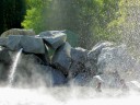 couple in rock lake spray